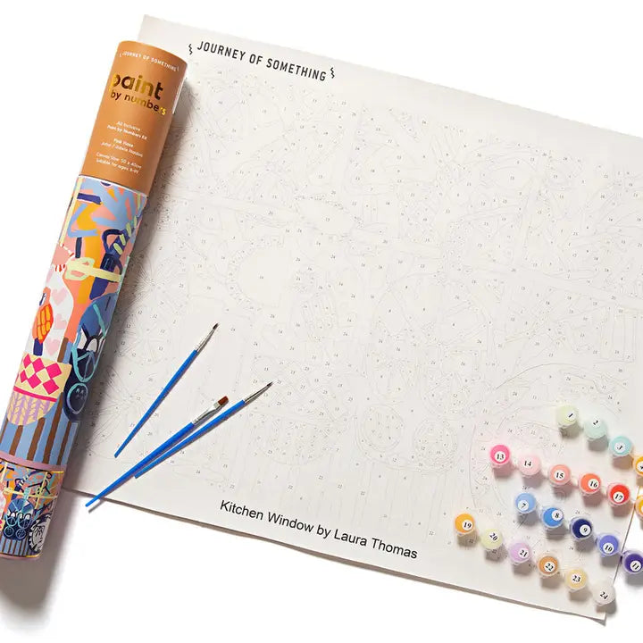 Artistic paint set with brushes and color swatches on a white surface