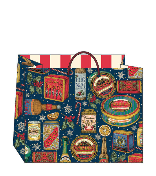 A festive Christmas-themed paper shopping bag featuring a dark blue background printed with vintage-style holiday illustrations, including candy canes, snowflakes, gift boxes, and red-and-white striped accents on the top.
