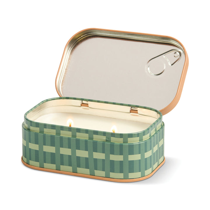 Green checkered candle in a tin with a white background