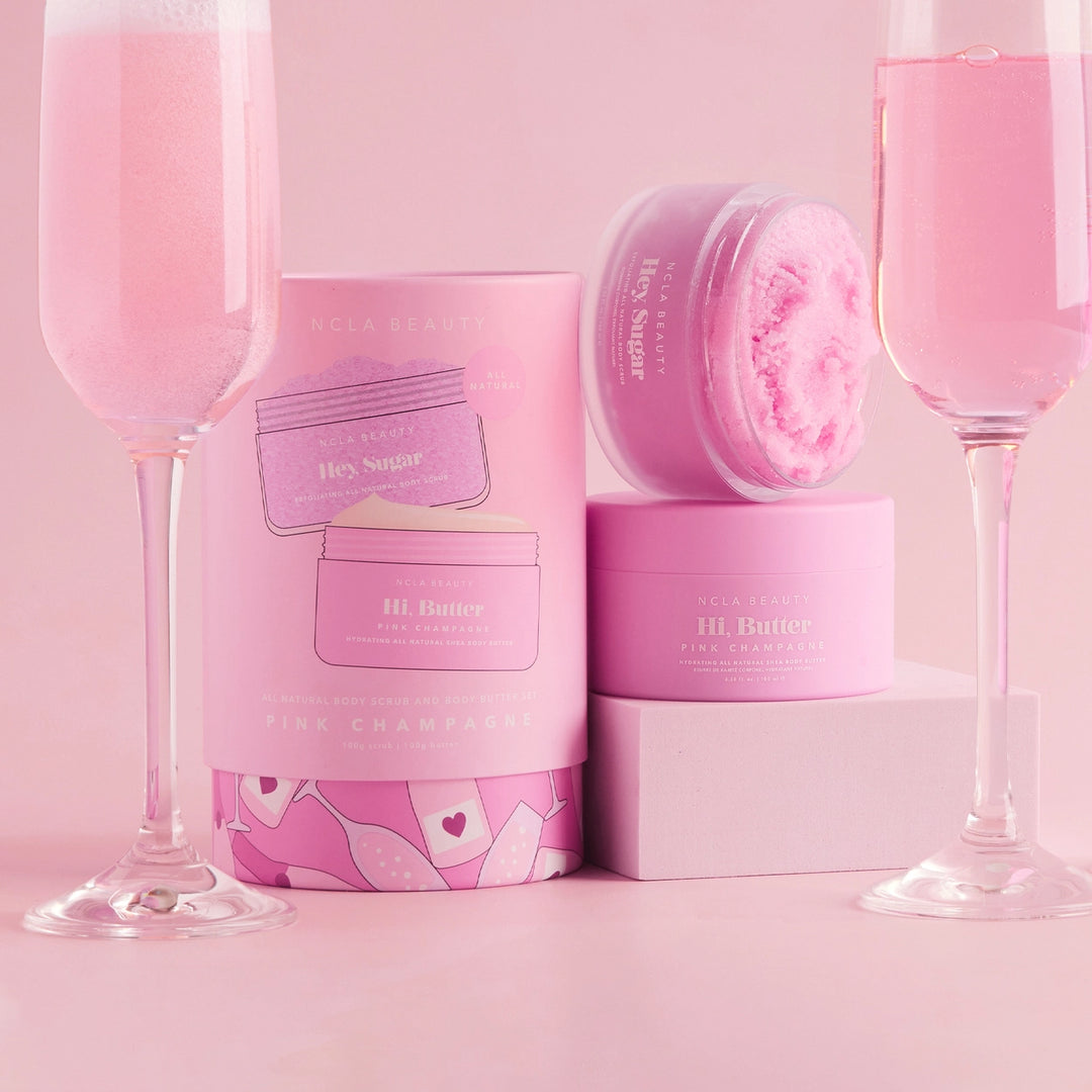 Pink skincare products and glasses on a pink background