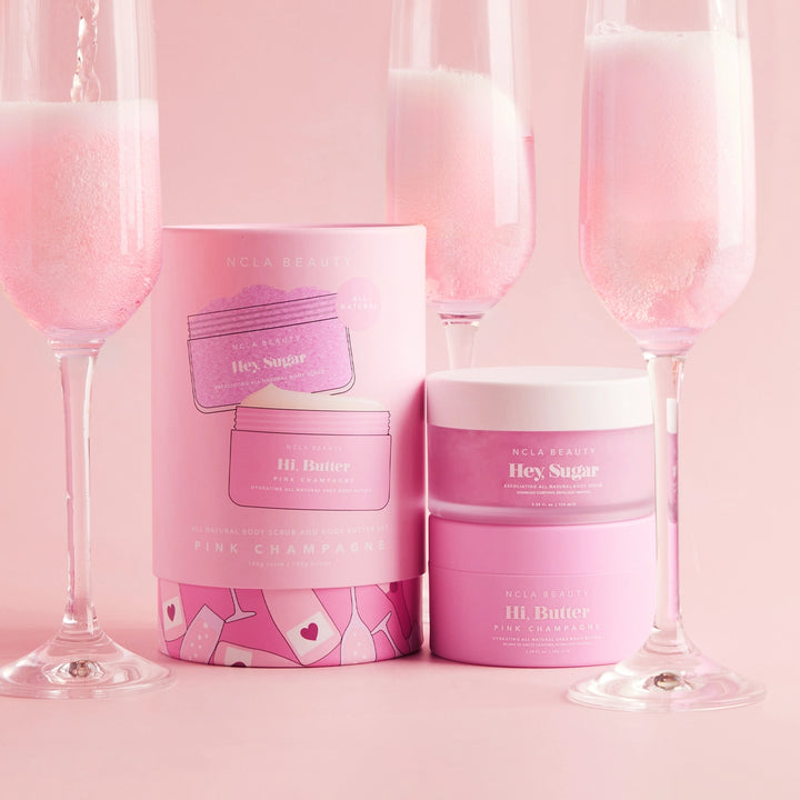 Pink beauty product packaging with champagne glasses on a pink background