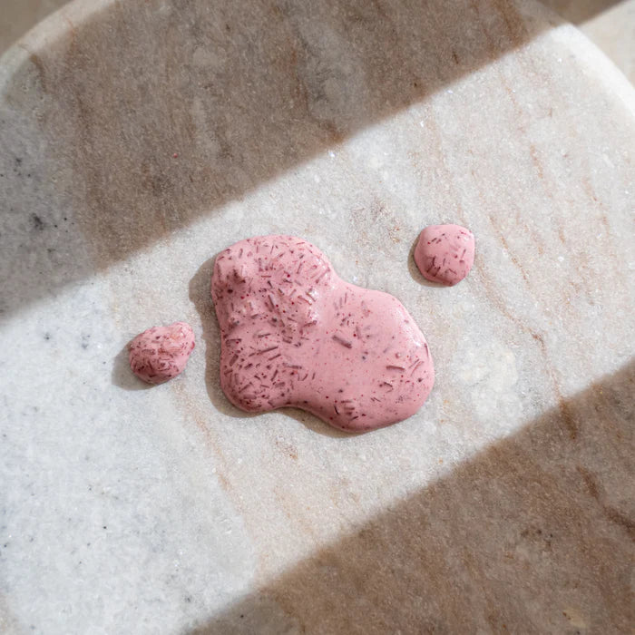Pink body scrub on a marbles surface