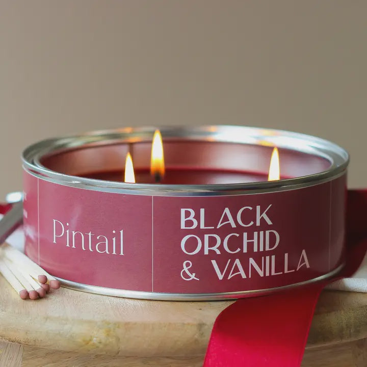 Candle in a red container labeled &