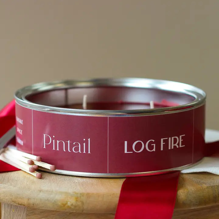 Candle in a red tin labeled &