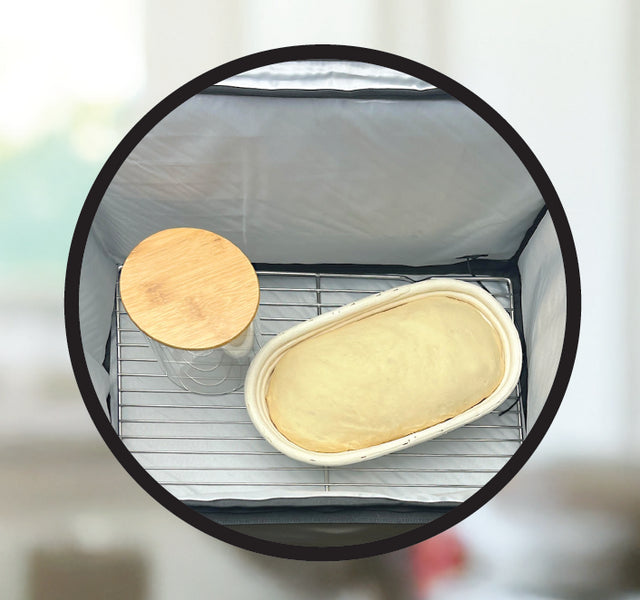 Round mirror reflecting a kitchen scene with a jar and container on a surface.