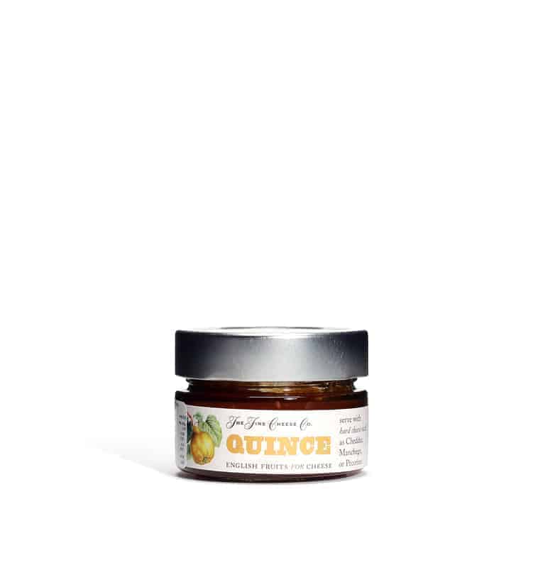 Jar of quince preserve with a white background