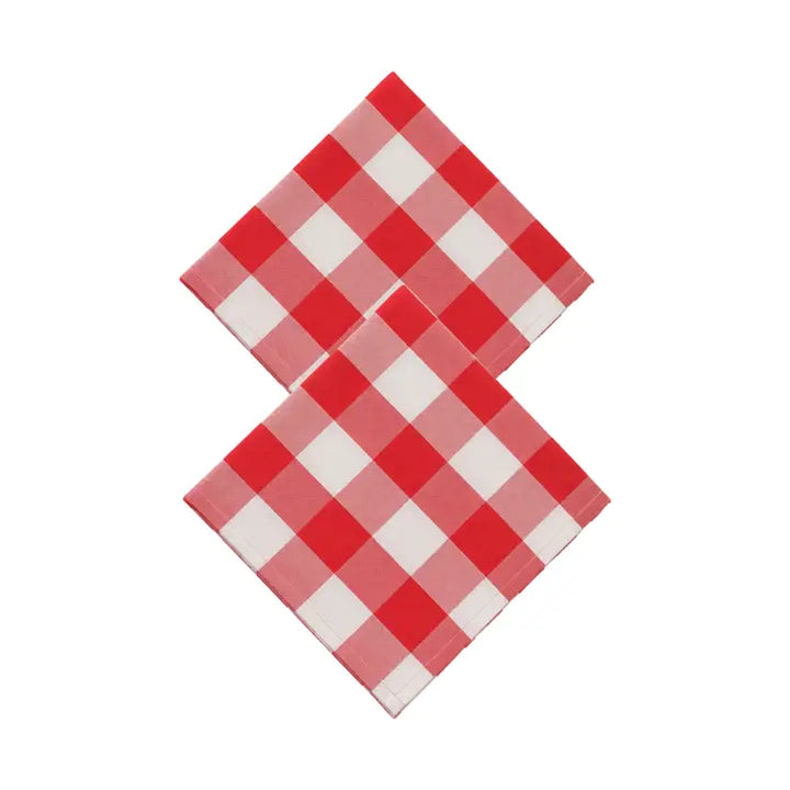 Two red and white checkered napkins arranged in an overlapping V-shape on a plain white background.