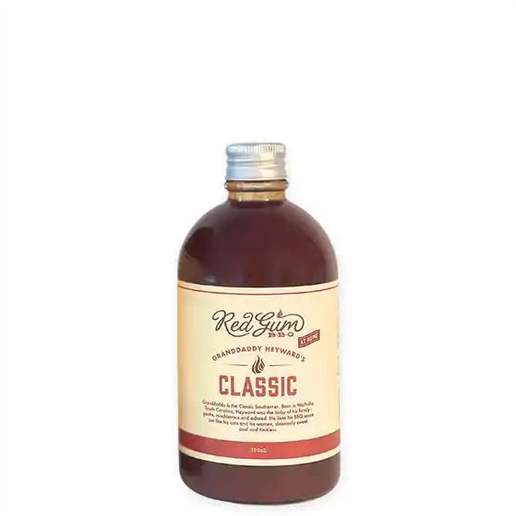 A 280ml bottle of Red Gum Syrup, Classic flavor, by Grandaddy Heywards. The bottle is made of dark amber-brown glass with a silver metal cap and a cream-colored label featuring red and black text.