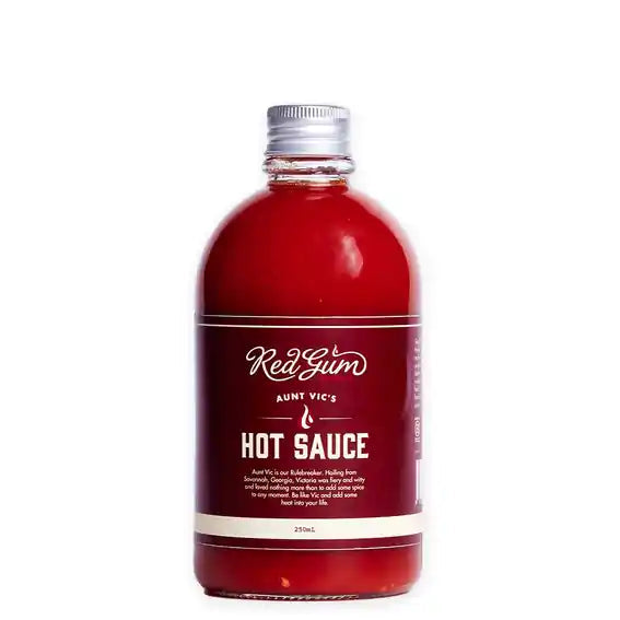 A 250ml bottle of Aunt Vic's Red Gum Hot Sauce, featuring a deep red liquid inside a clear bottle with a silver metal cap and a dark red label with white text.