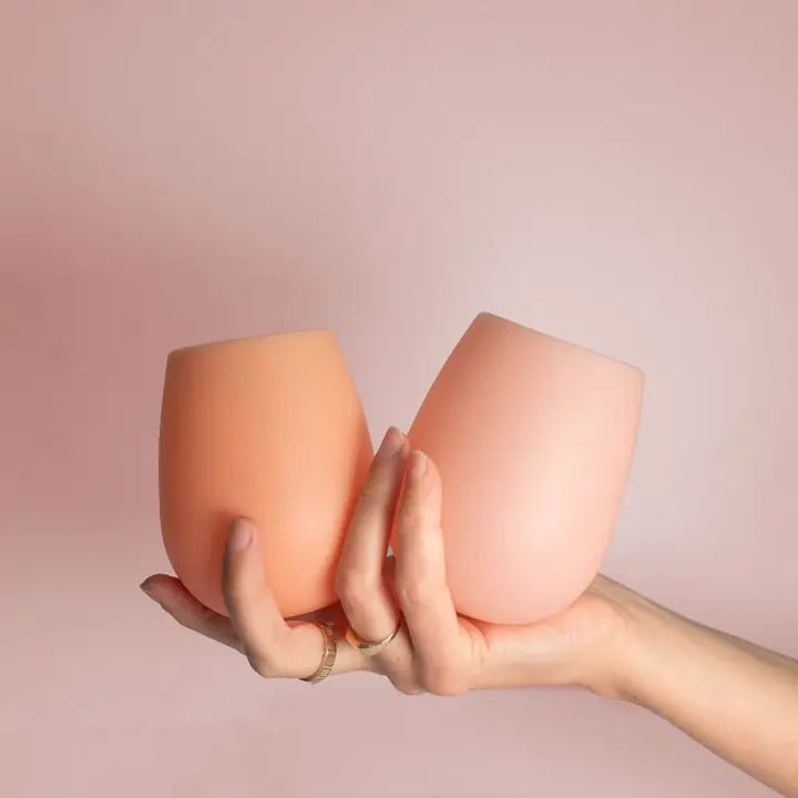 Two matte silicone cups held in a person&