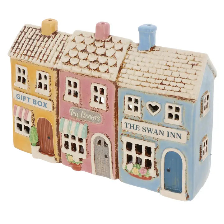 Colorful miniature model of a row of shops with different names on a white background