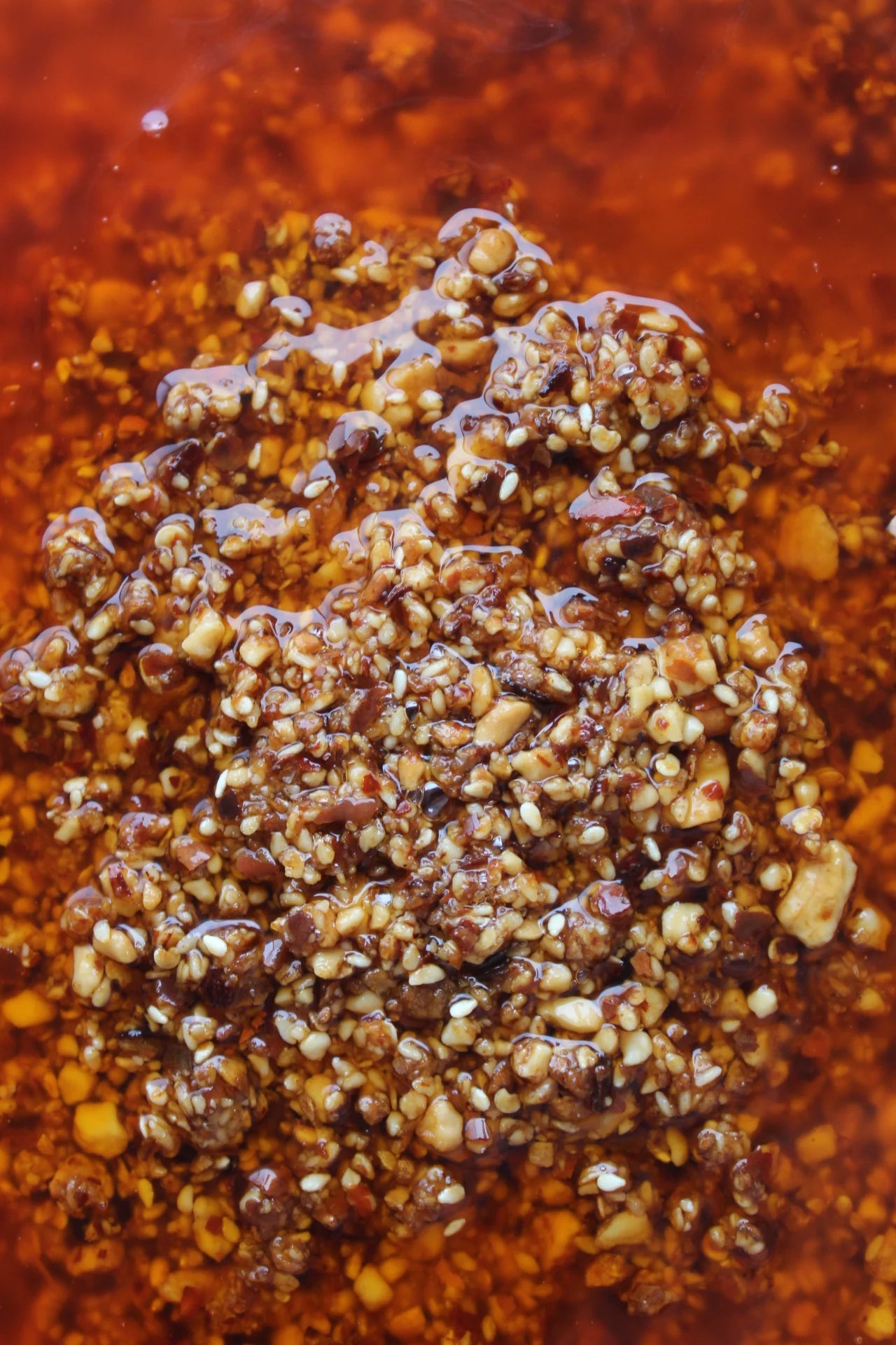 Close-up of a textured brown paste on a dark background