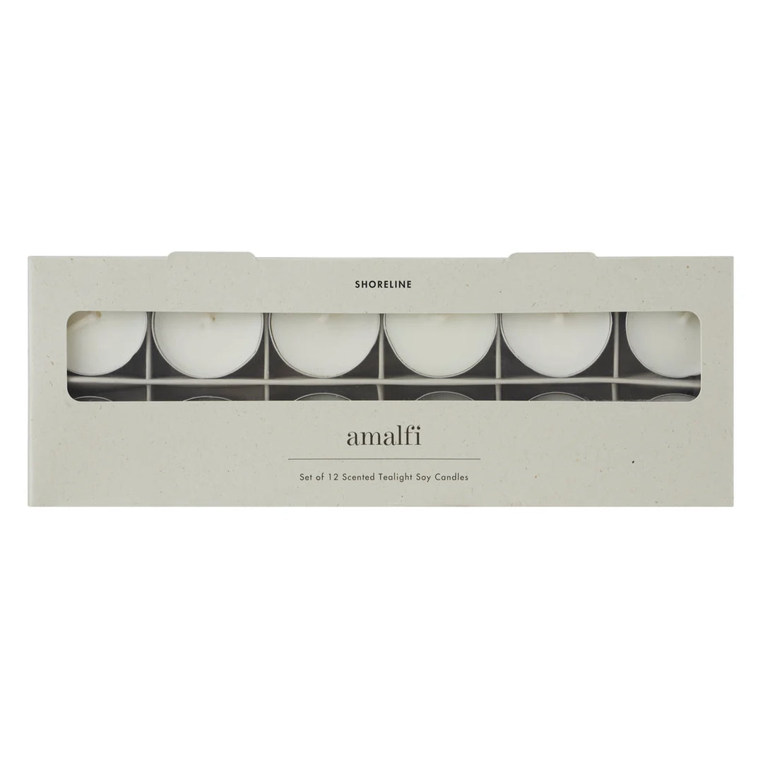Amalfi Shoreline set of 12 scented twilight soy candles in a rectangular kraft paper box with a clear window showing the white candles inside.
