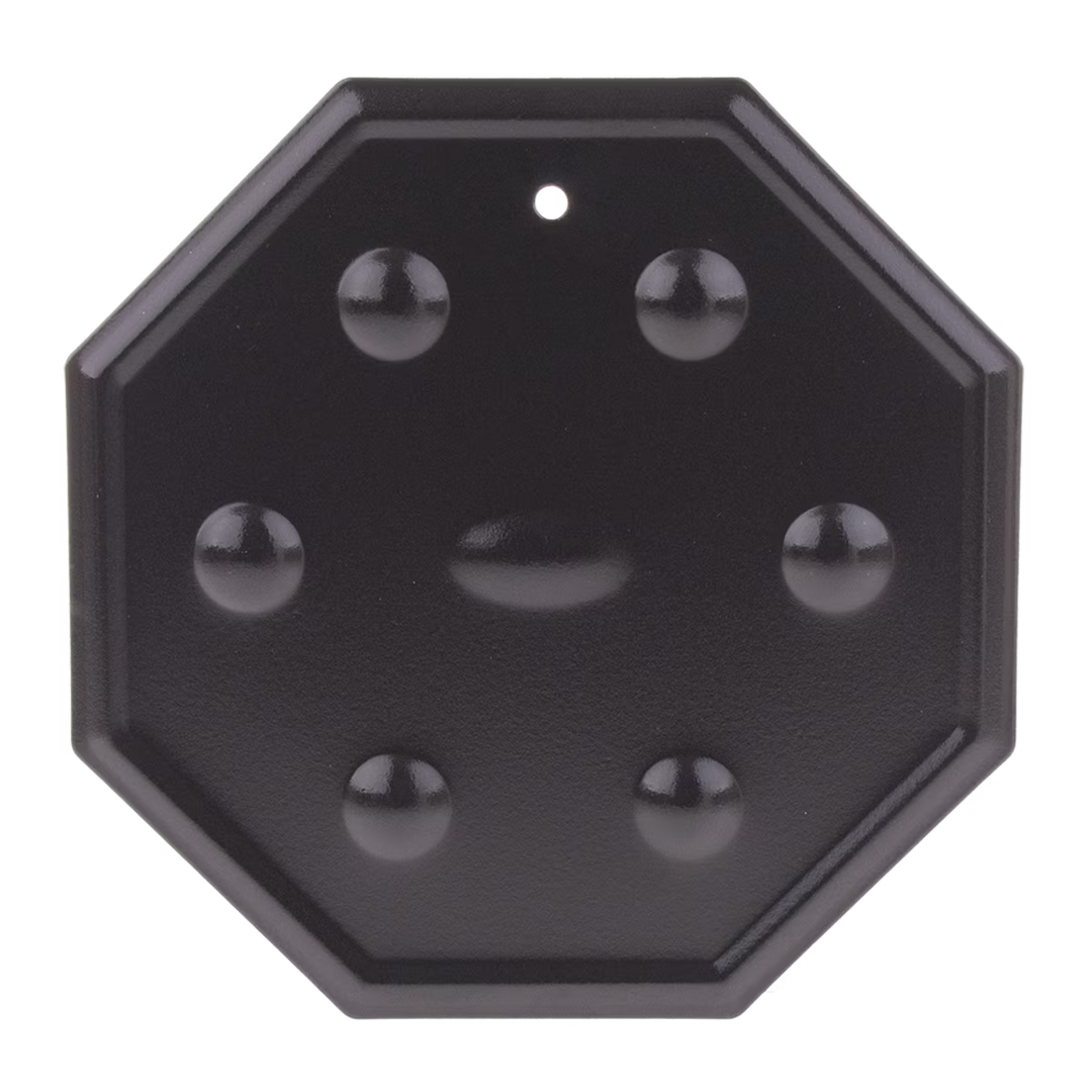 Black octagonal simmer mat with spherical protrusions on a white background