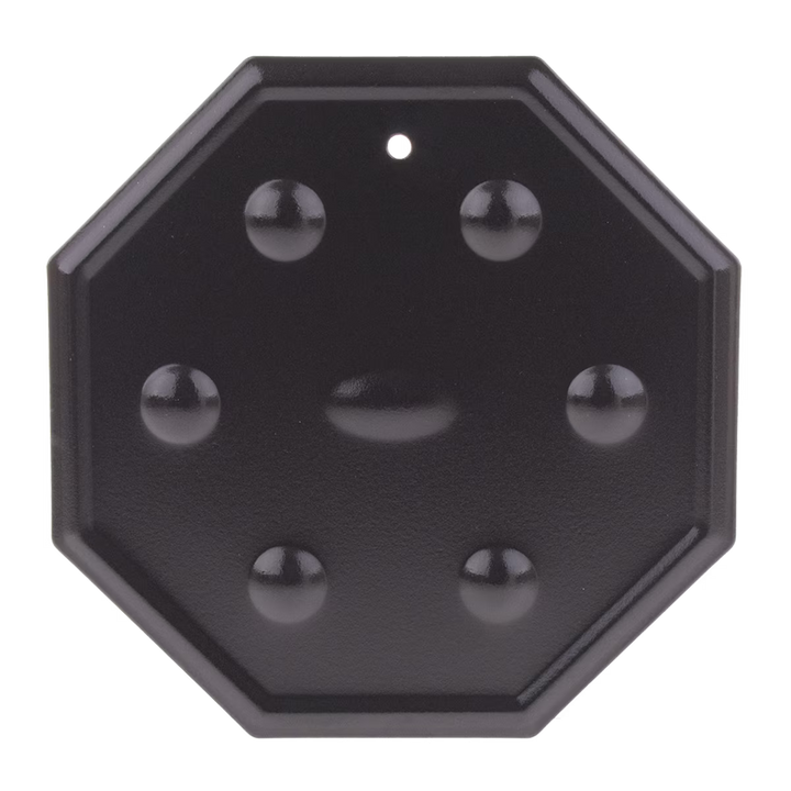 Black octagonal simmer mat with spherical protrusions on a white background