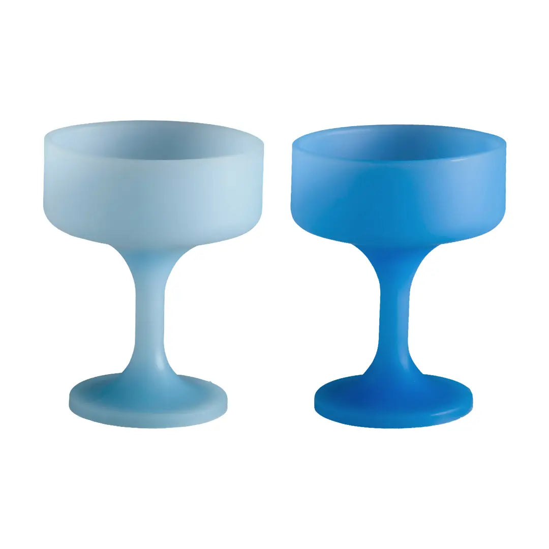 Two blue stemmed silicone cocktail glasses on a white background