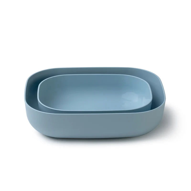 A set of two nested rectangular shallow bowls with rounded corners in a dusty light blue color, photographed on a clean white background.