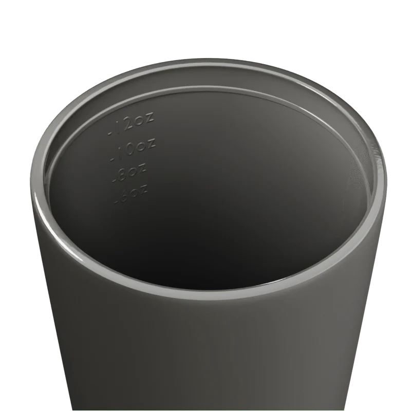 Inside of a grey travel mug with measurement markings on a white background