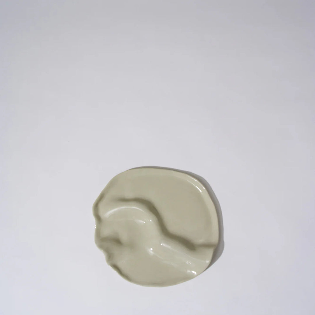 Beige ceramic dish on a white background