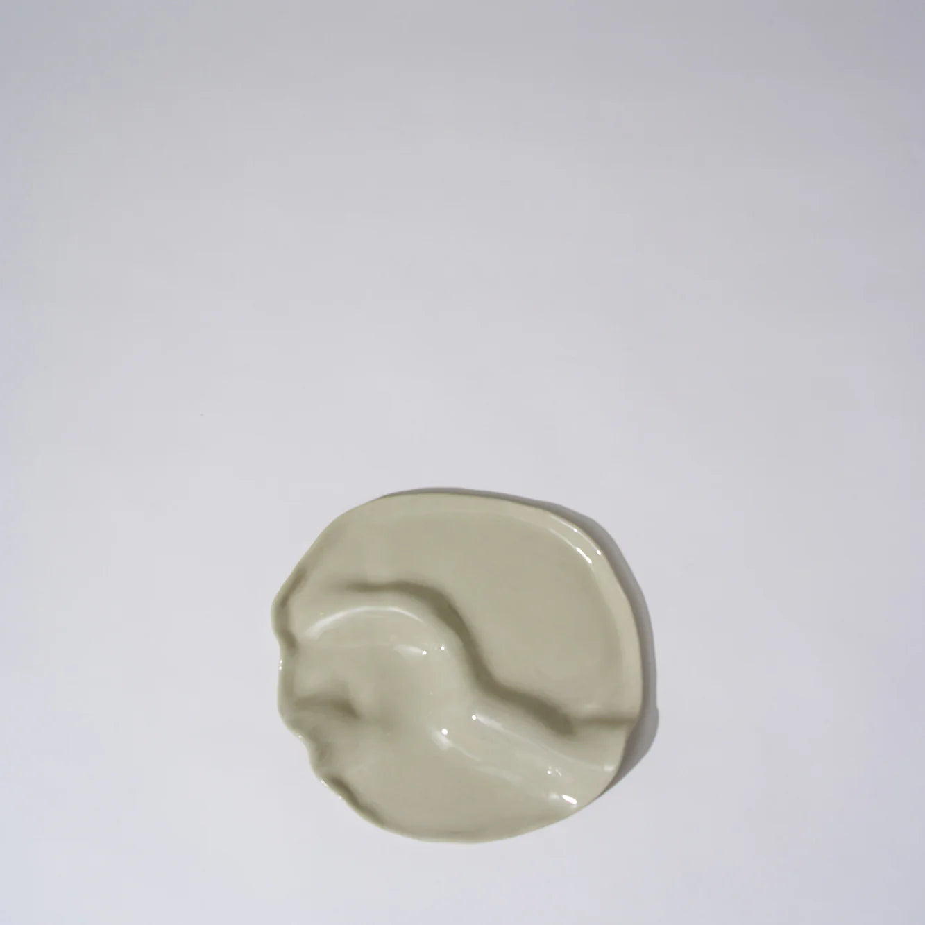Beige ceramic dish on a white background