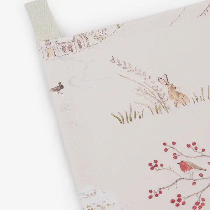 Cream coloured tea towel with winder Christmas design print including a robin, tree with berries, hare and grass