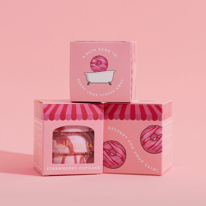 Pink packaging of a bath bomb with &