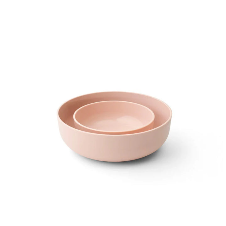 Two blush storage bowls on a white background