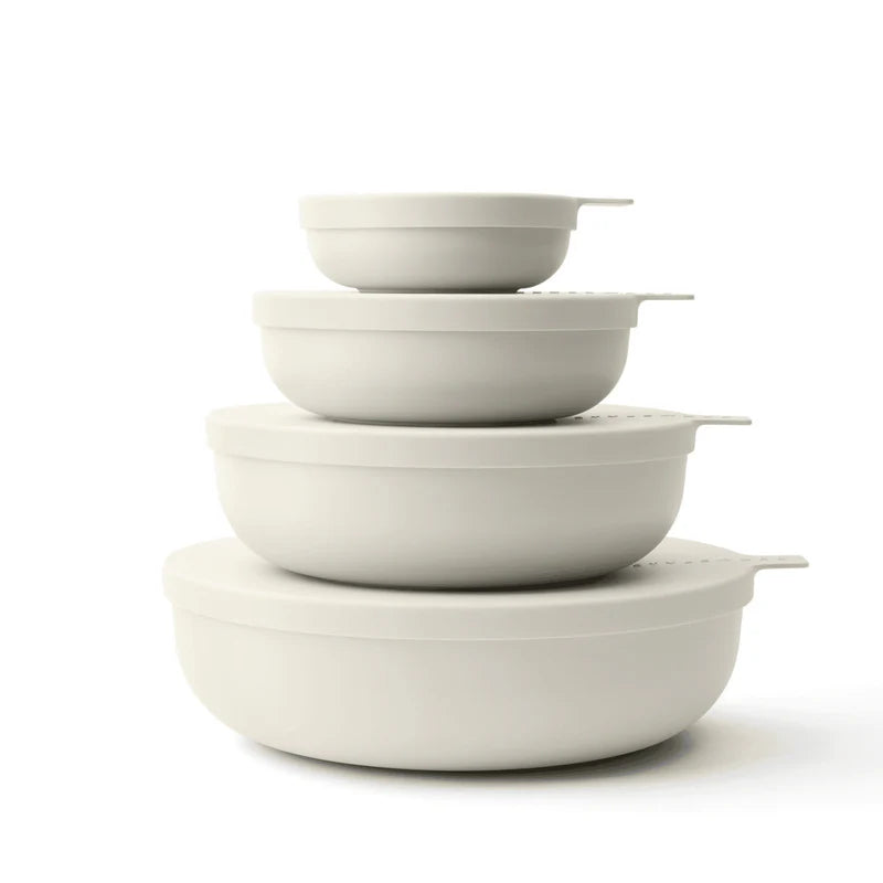 Four nested round bowls in off-white color, arranged by size with matching lids, on a clean white background.