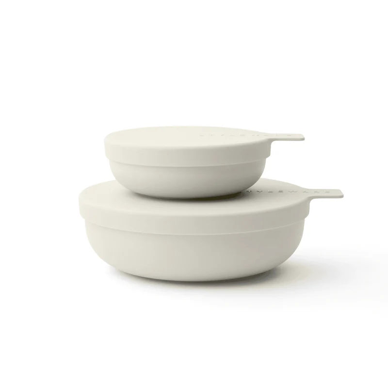 Two matte off-white plastic nesting bowls with matching lids, stacked on a clean white background.