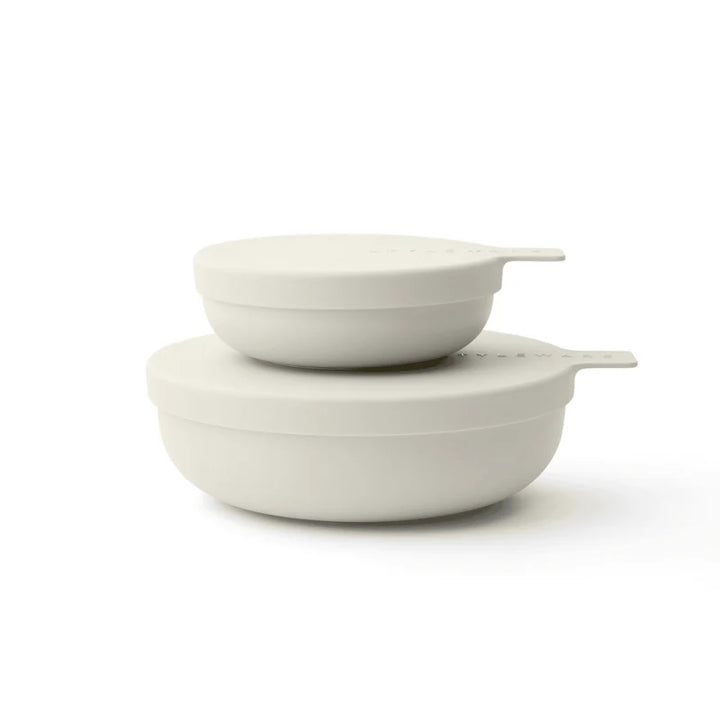 Two matte off-white plastic nesting bowls with matching lids, stacked on a clean white background.