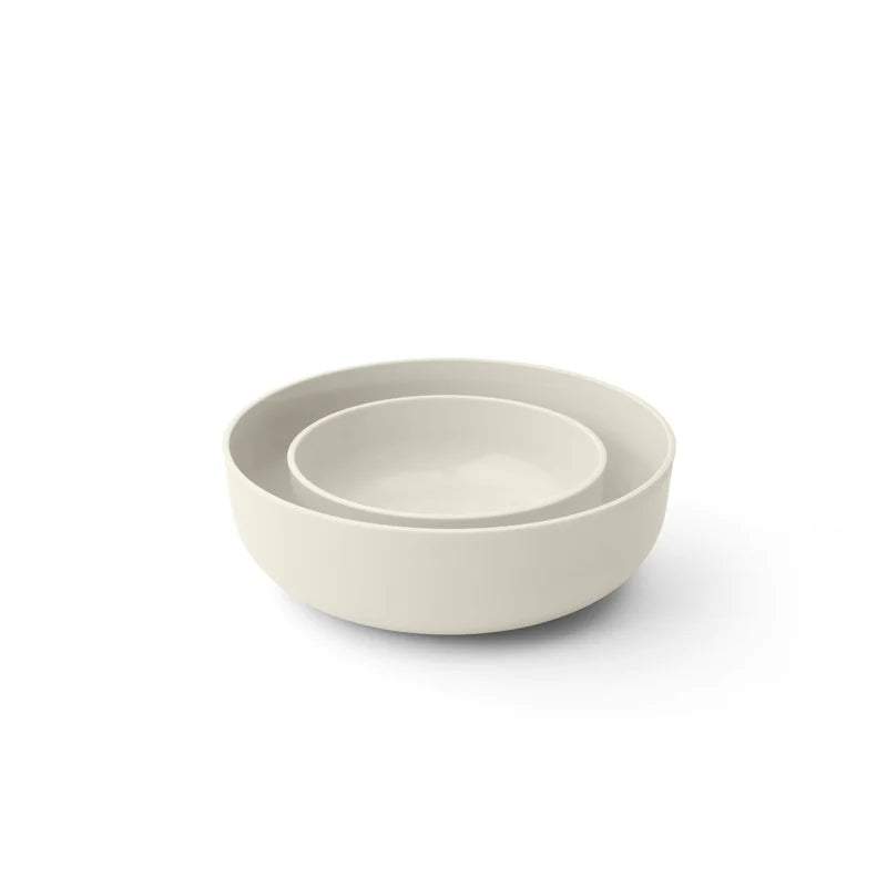 Two off white bowls stacked on a white background