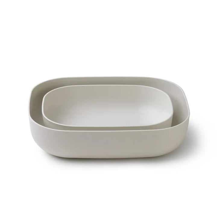 Two nested rectangular storage containers with rounded corners in a light warm gray or off-white color, shown on a clean white background.