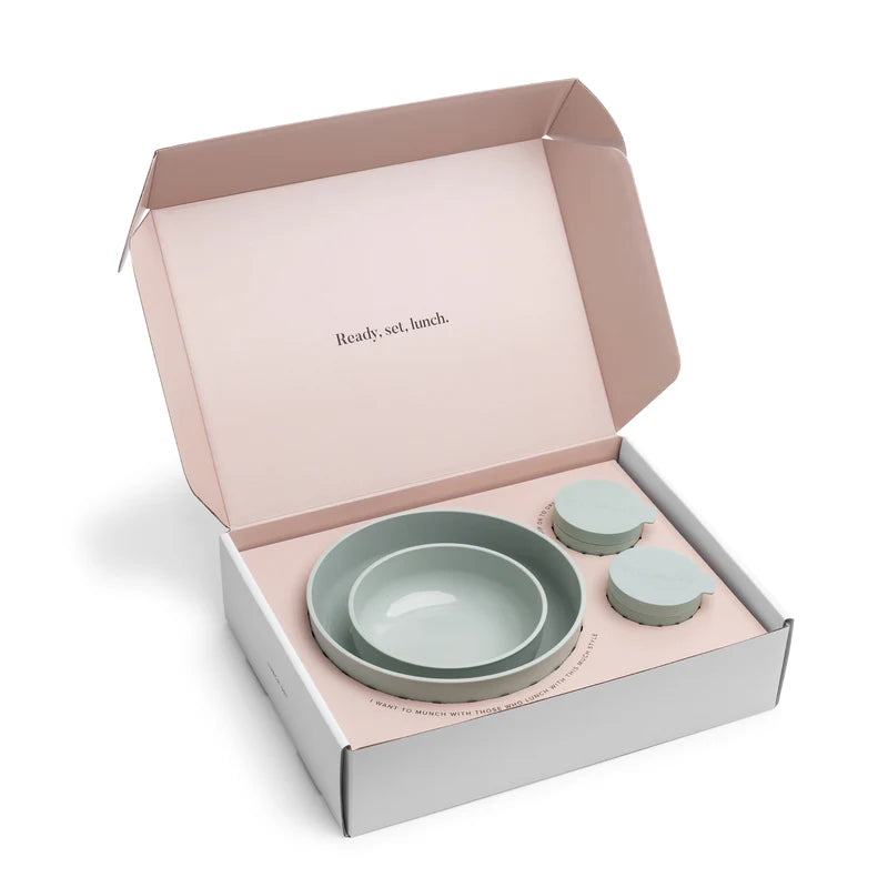 Set of plastic sage green bowls in a box with 'Ready, set, lunch.' text on a white background