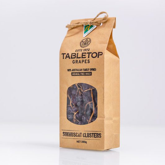 Kraft paper packaging of Tabletop Grapes with a clear window showing the product on a white background.