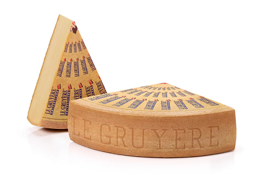 Two Le Gruyère cheese wheels on a white background