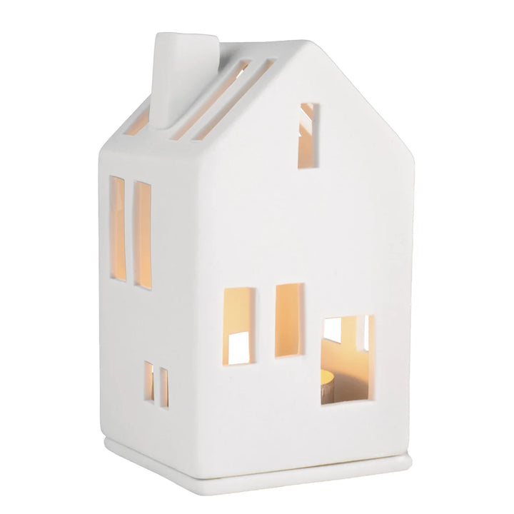White porcelain tealight house with lit candle inside