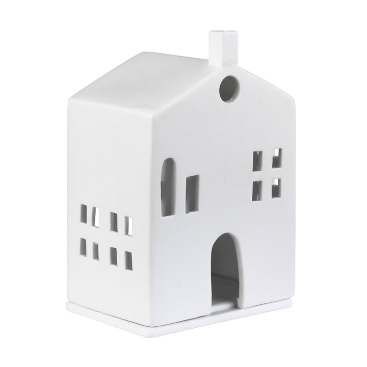 White porcelain tealight house candle holder on a white background