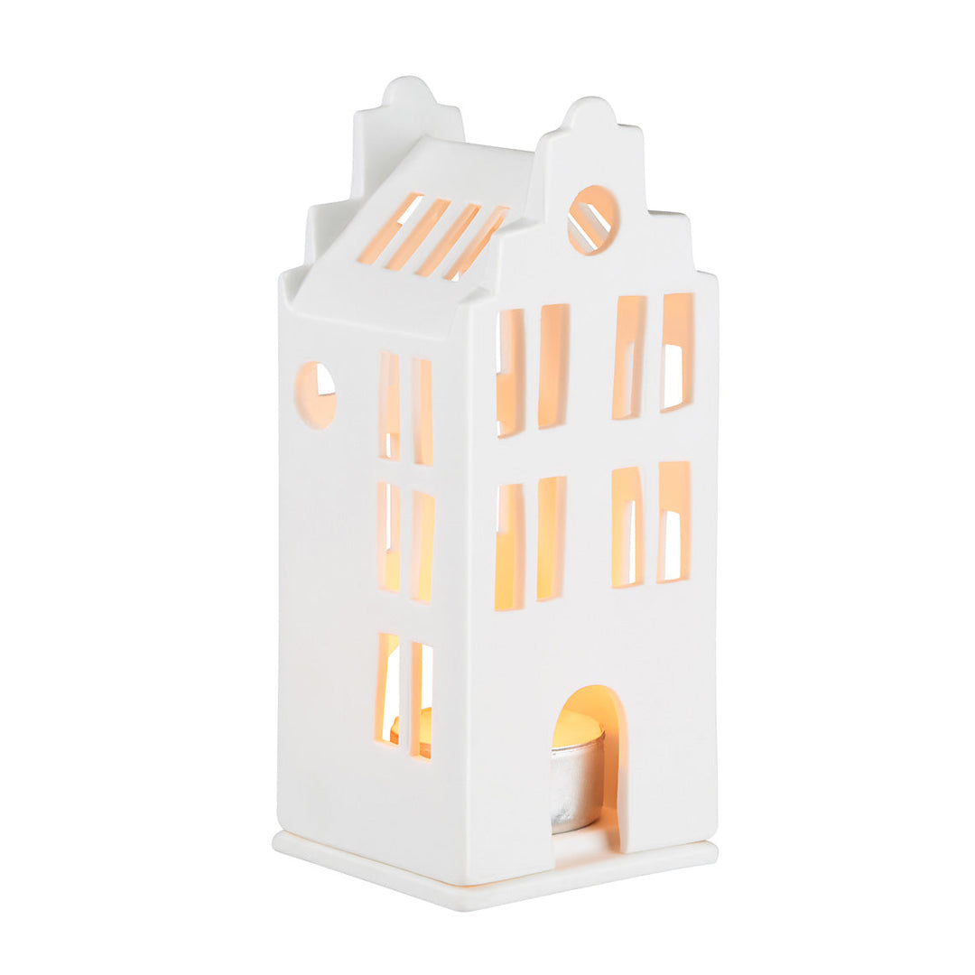 White porcelain tealight house candle holder with lit candle inside