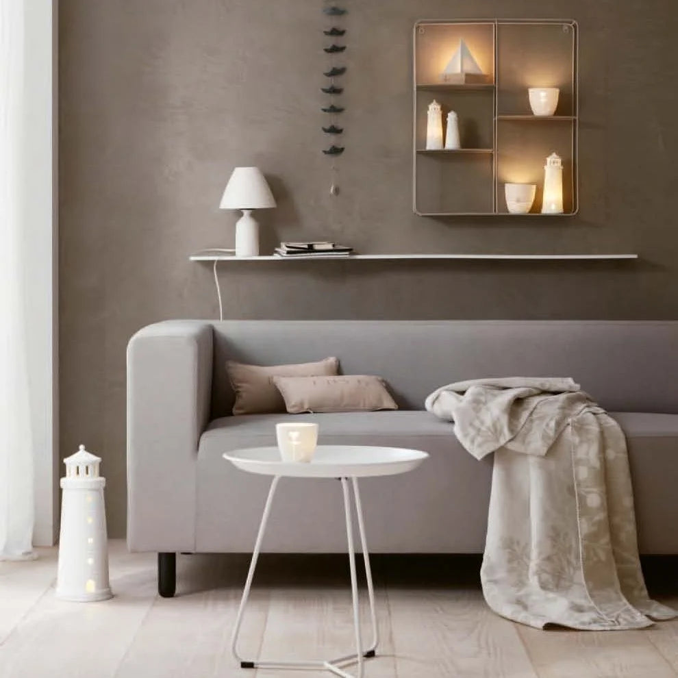 Lounge scene with white tealight house candle holders on a wall shelf