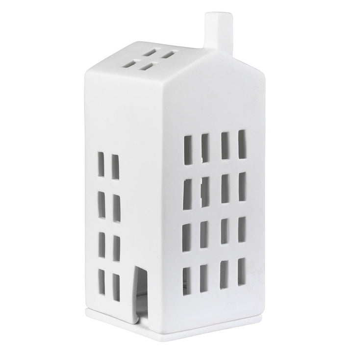 A white ceramic house-shaped candle holder with cutout windows and a small chimney, shown on a plain white background.
