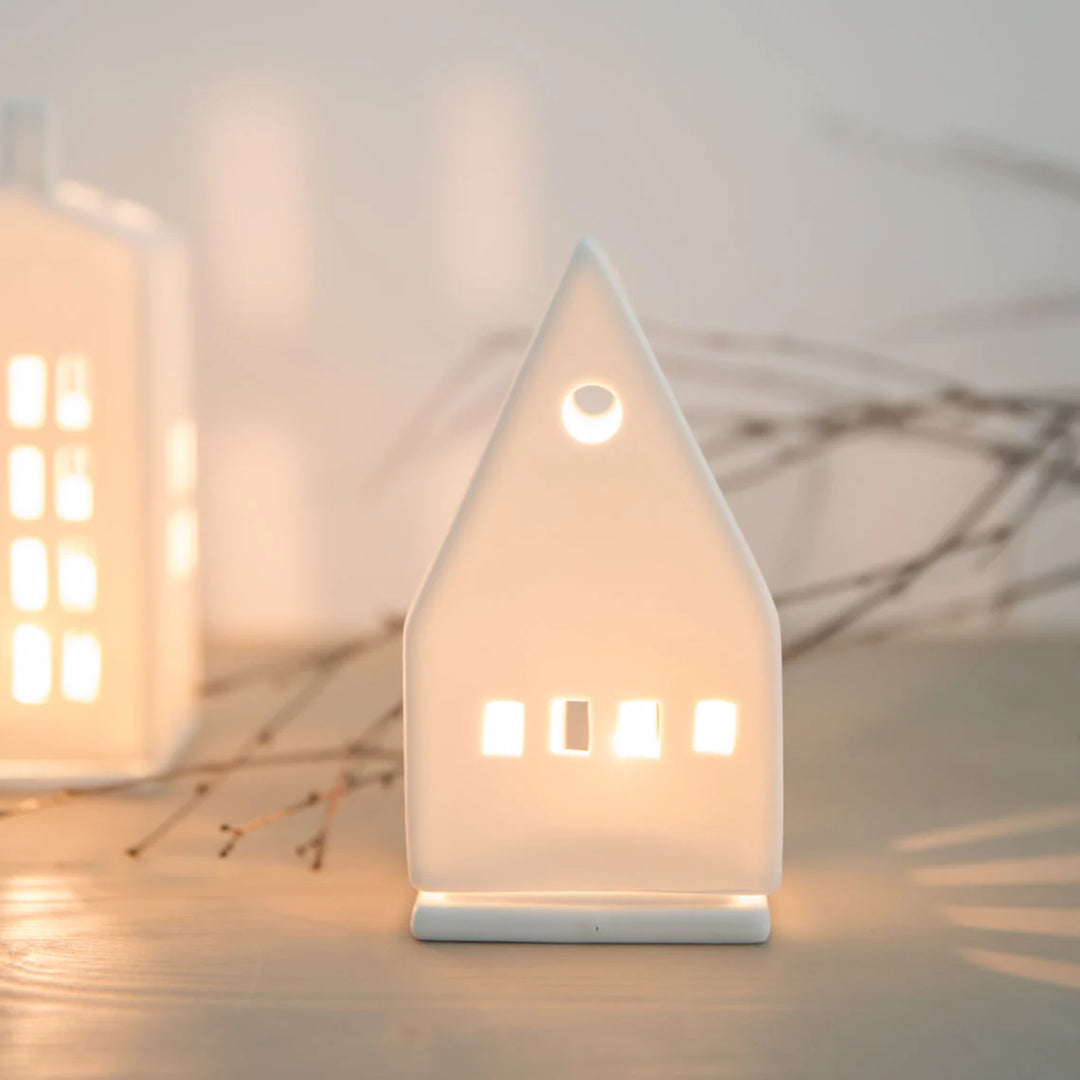 Small porcelain tealight house candle holder with lit candle