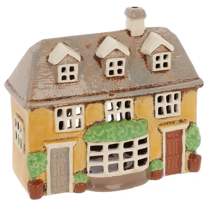 Ceramic house-shaped candle holder with a white roof and yellow body on a white background