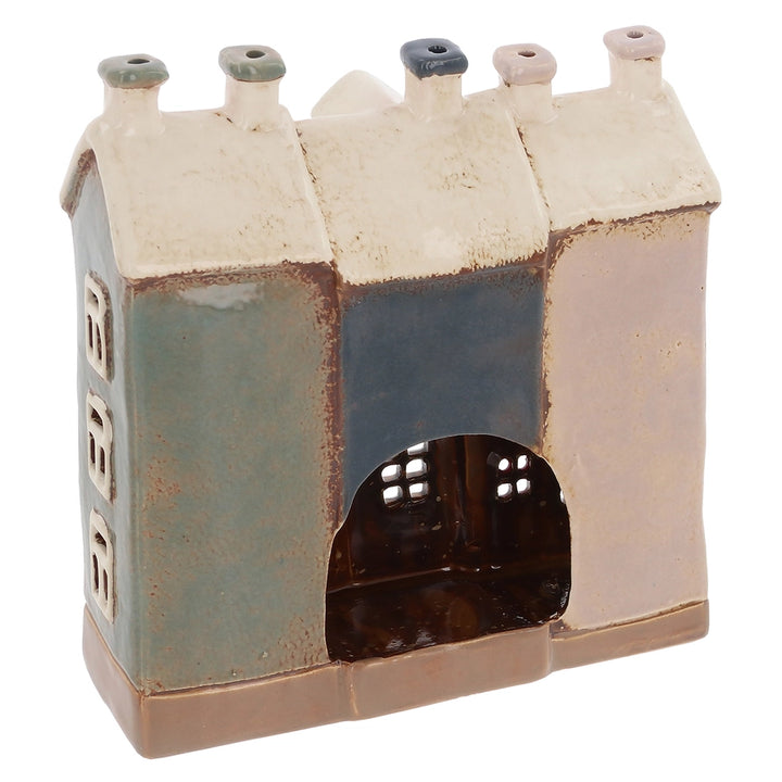 Ceramic house-shaped tealight holder with a textured surface on a white background