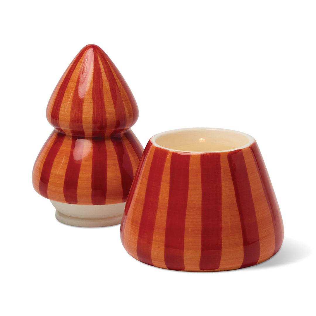 Ceramic Christmas tree candle with red and orange stripes with the lid off on a white background