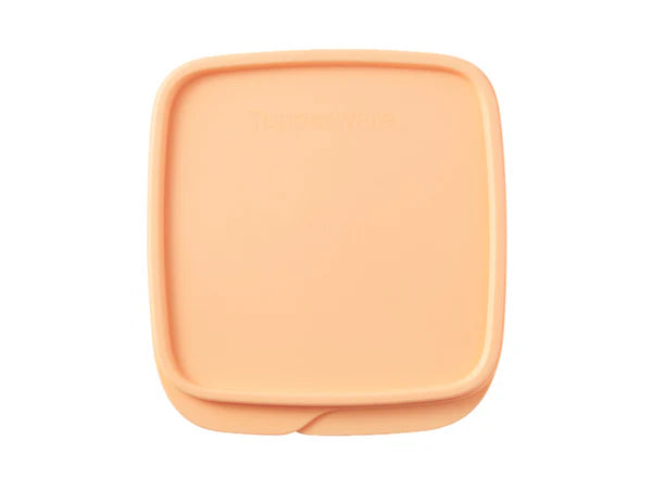 A peach-colored square plastic container lid with rounded corners, shown from a top-down view on a white background.