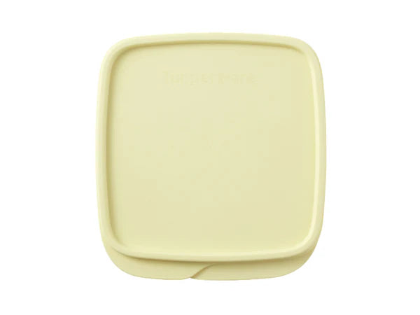 A pale yellow Tupperware square container lid with rounded corners, shown from a top-down view on a white background.