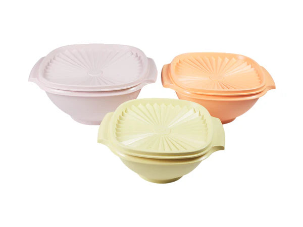 Three colorful bowls with lids on a white background