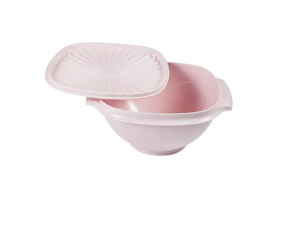 Pink plastic food container with lid on a white background