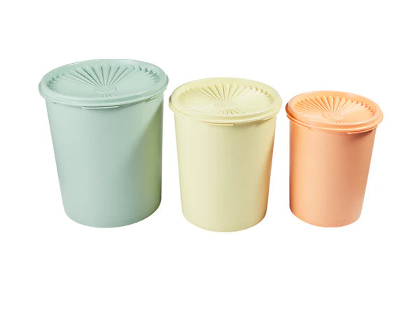 Three pastel-colored containers with lids on a white background