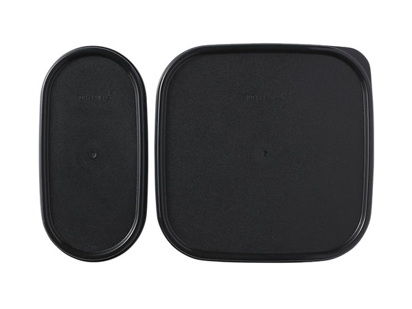 Two black plastic lids on a white background